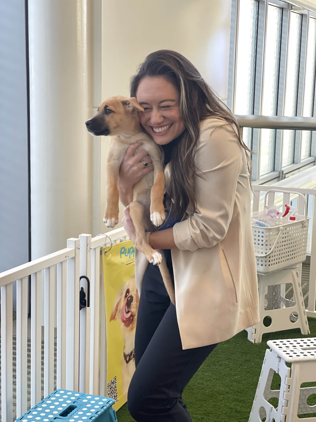 A happy man holding an adorable puppy - thanks to Puppy Love and our workplace events in your local area, {fran_state_abbrev}.